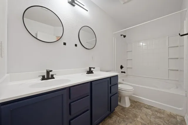 a bathroom with a toilet a sink and a mirror