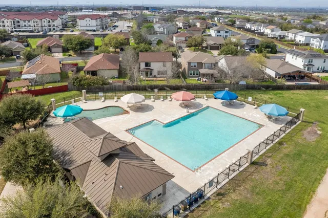 an aerial view of a house with a garden and lake view