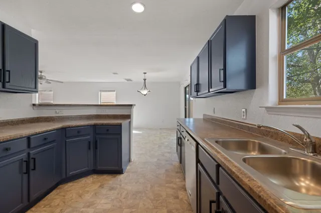 a kitchen that has a sink and a stove in it