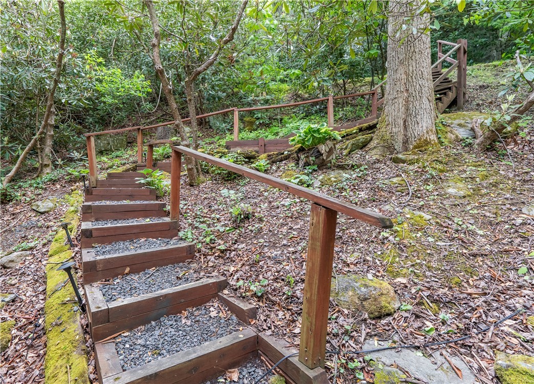 141 Snowflake Road Banner Elk, NC 28604 - Photo 26 of 28 a view of stairs and yard with wooden fence