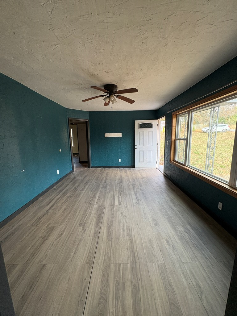 62 Pleasant Hill Road Murphy, NC 28906 - Photo 13 of 28 wooden floor in an empty room with a window
