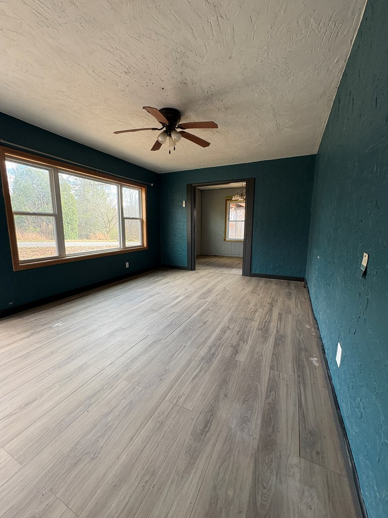 62 Pleasant Hill Road Murphy, NC 28906 - Photo 14 of 28 wooden floor in an empty room with a window