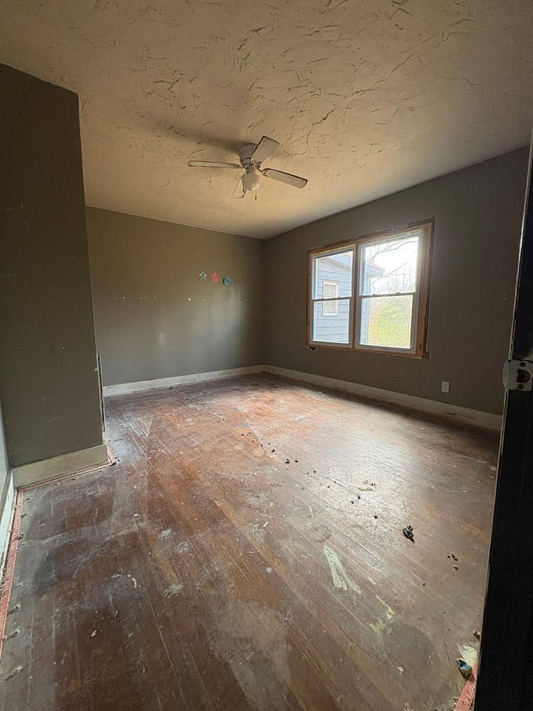 62 Pleasant Hill Road Murphy, NC 28906 - Photo 15 of 28 en empty room with windows and ceiling fan