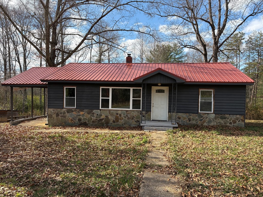 62 Pleasant Hill Road Murphy, NC 28906 - Photo 2 of 28 a front view of a house with a garden and yard