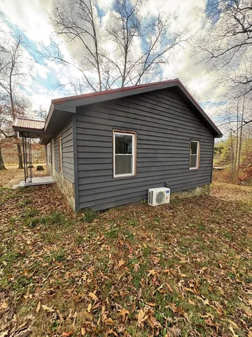 a backyard of a house with large trees and brick walls