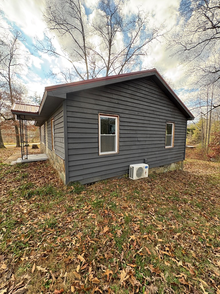 62 Pleasant Hill Road Murphy, NC 28906 - Photo 23 of 28 a backyard of a house with large trees and brick walls
