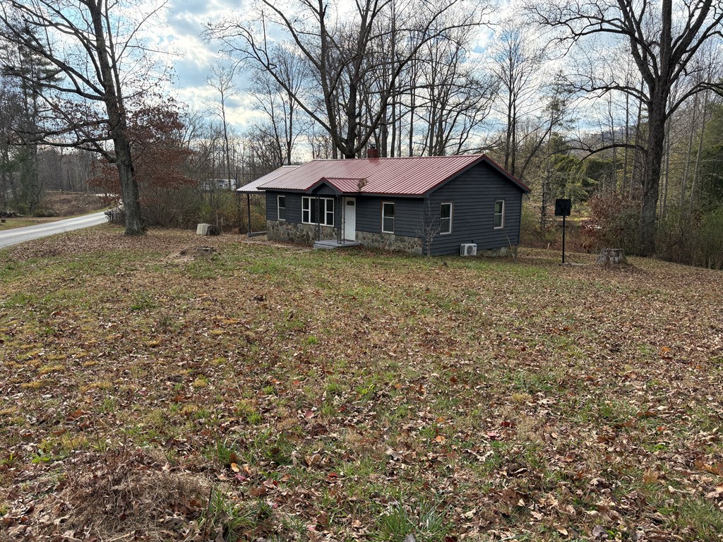 62 Pleasant Hill Road Murphy, NC 28906 - Photo 27 of 28 a barn with a table and chairs under an umbrella