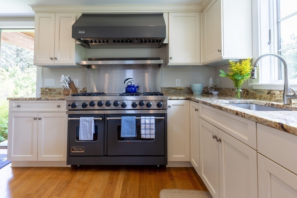 12 A Pond View Drive, Unit COTTAGE Nantucket, MA 02554 - Photo 7 of 14 a kitchen with stainless steel appliances granite countertop a stove a sink and a microwave