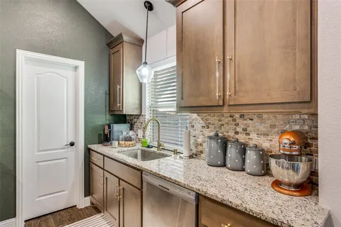 a kitchen with sink and cabinets