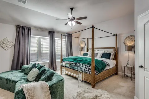 a bedroom with a bed mirror and window
