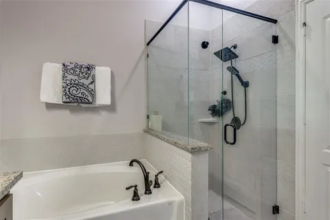 a bathroom with a bath tub and shower