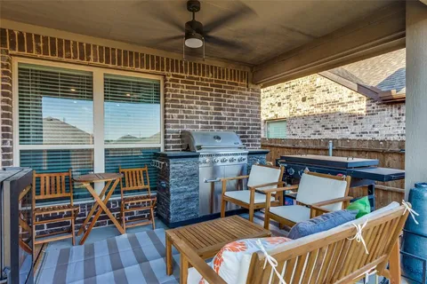a view of a chairs and table in the balcony