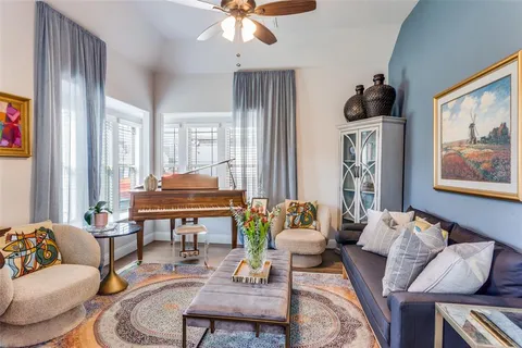 a living room with furniture and wooden floor