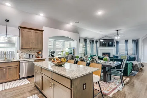 a kitchen with a counter top space a sink cabinets and appliances