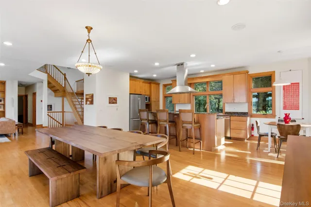 a view of a dining room with furniture large windows and wooden floor