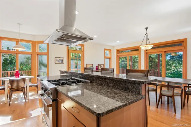 a bathroom with a granite countertop sink and a large window