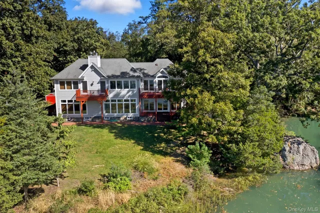 a aerial view of a house with a big yard plants and large trees