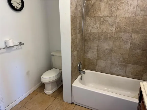 a bathroom with a toilet a sink and bathtub