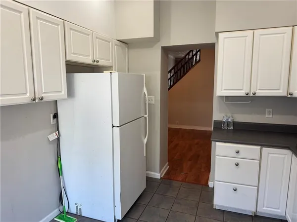 a white refrigerator freezer sitting in a kitchen