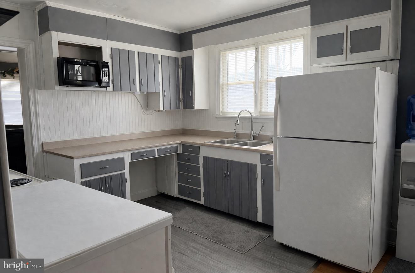 7103 Marye Road Spotsylvania, VA 22551 - Photo 2 of 3 a kitchen with a refrigerator sink and cabinets