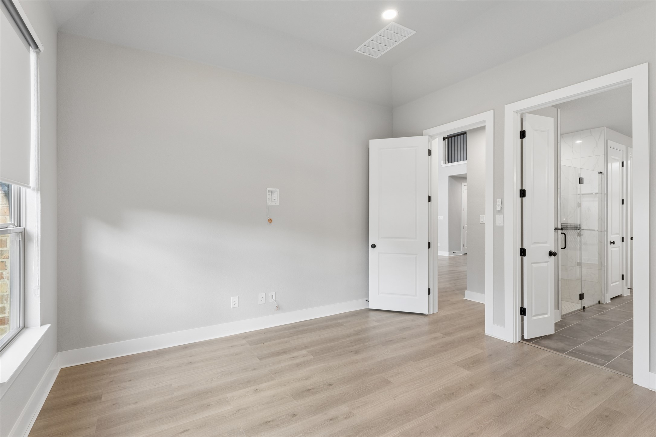 1508 Cardinal Lane Round Rock, TX 78681 - Photo 19 of 35 Unfurnished bedroom with light wood-style floors and ensuite bathroom