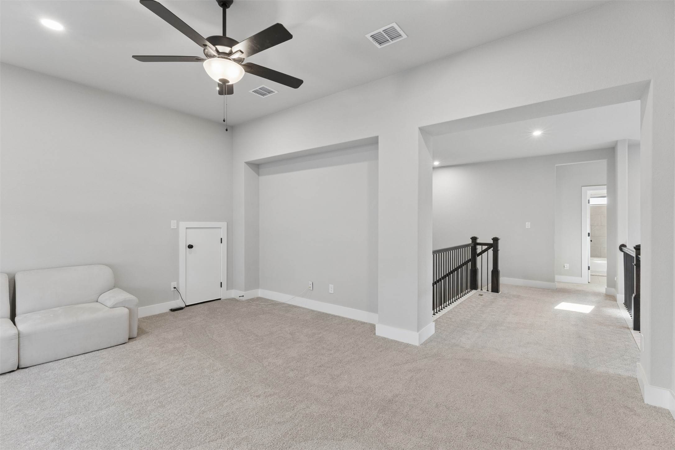 1508 Cardinal Lane Round Rock, TX 78681 - Photo 25 of 35 Unfurnished room with an upstairs landing, recessed lighting, light carpet, and a ceiling fan