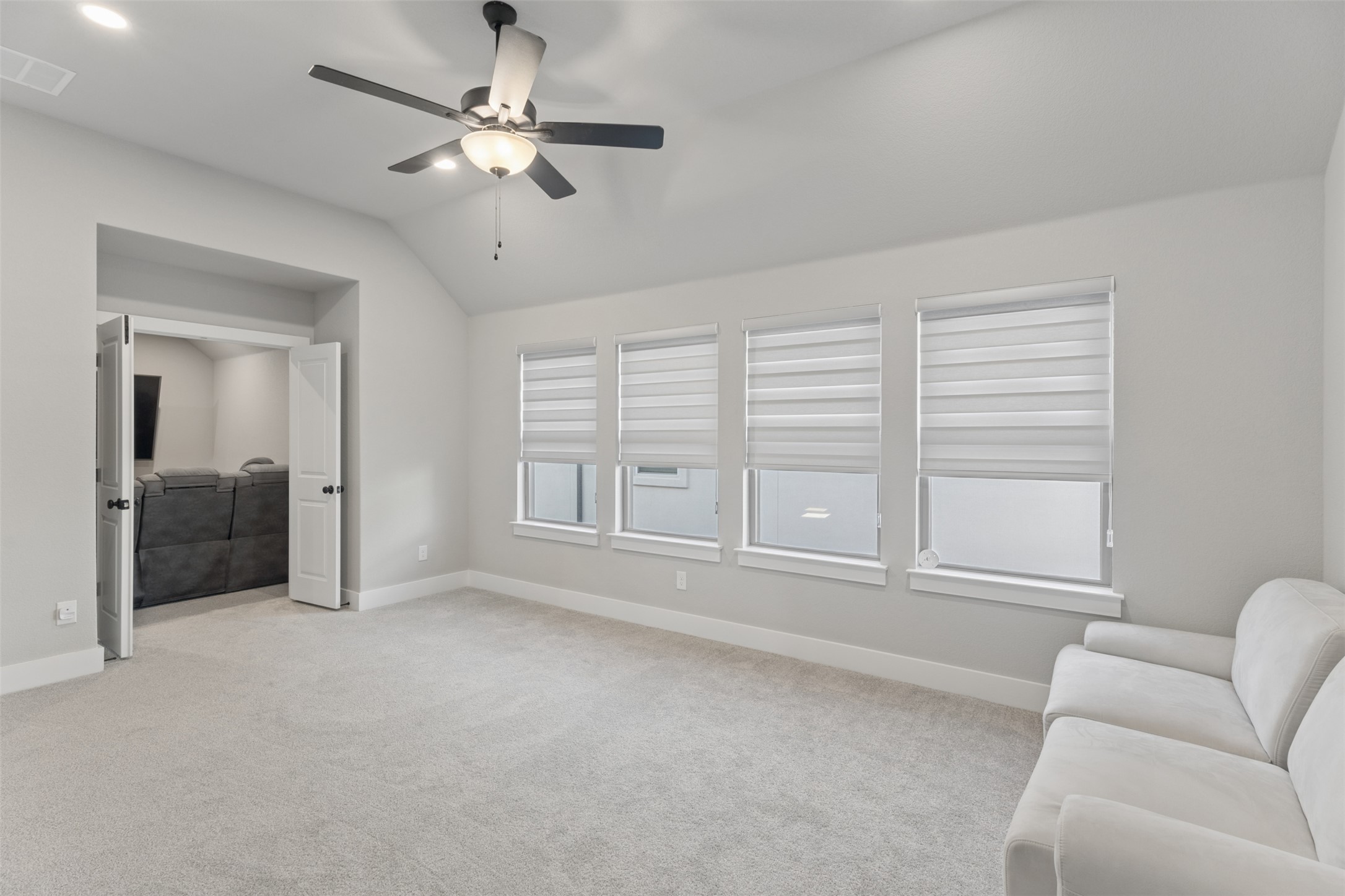 1508 Cardinal Lane Round Rock, TX 78681 - Photo 26 of 35 Sitting room with ceiling fan, vaulted ceiling, light colored carpet, and recessed lighting
