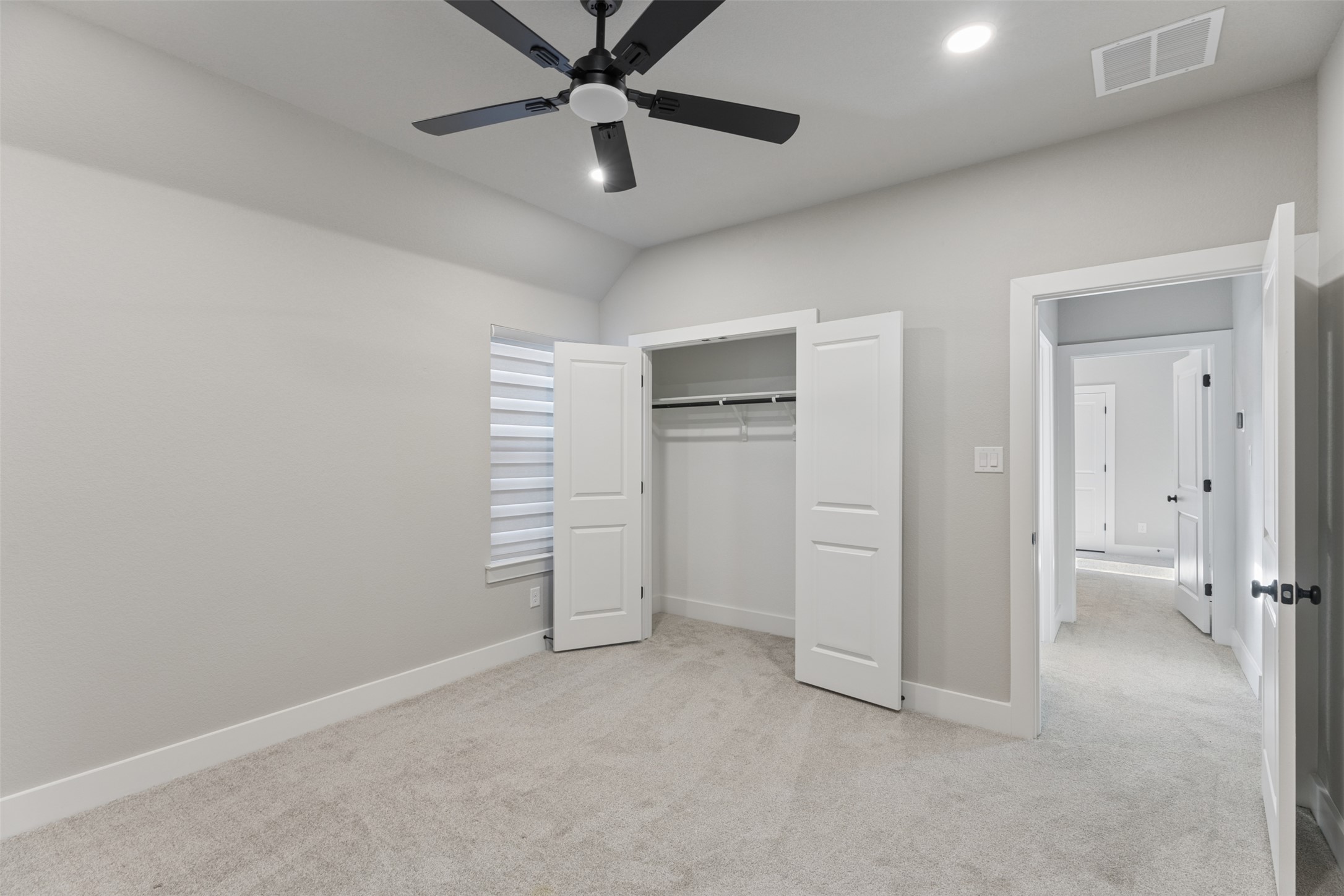 1508 Cardinal Lane Round Rock, TX 78681 - Photo 30 of 35 Unfurnished bedroom featuring light colored carpet, ceiling fan, a closet, and recessed lighting