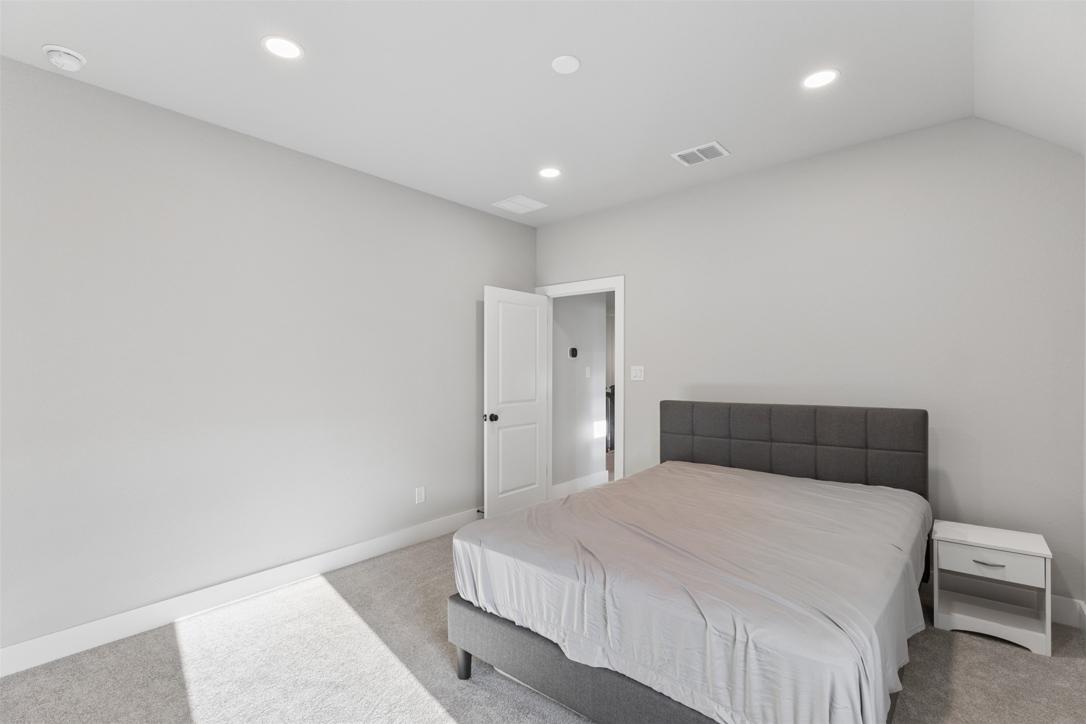 1508 Cardinal Lane Round Rock, TX 78681 - Photo 31 of 35 Bedroom with light colored carpet and recessed lighting