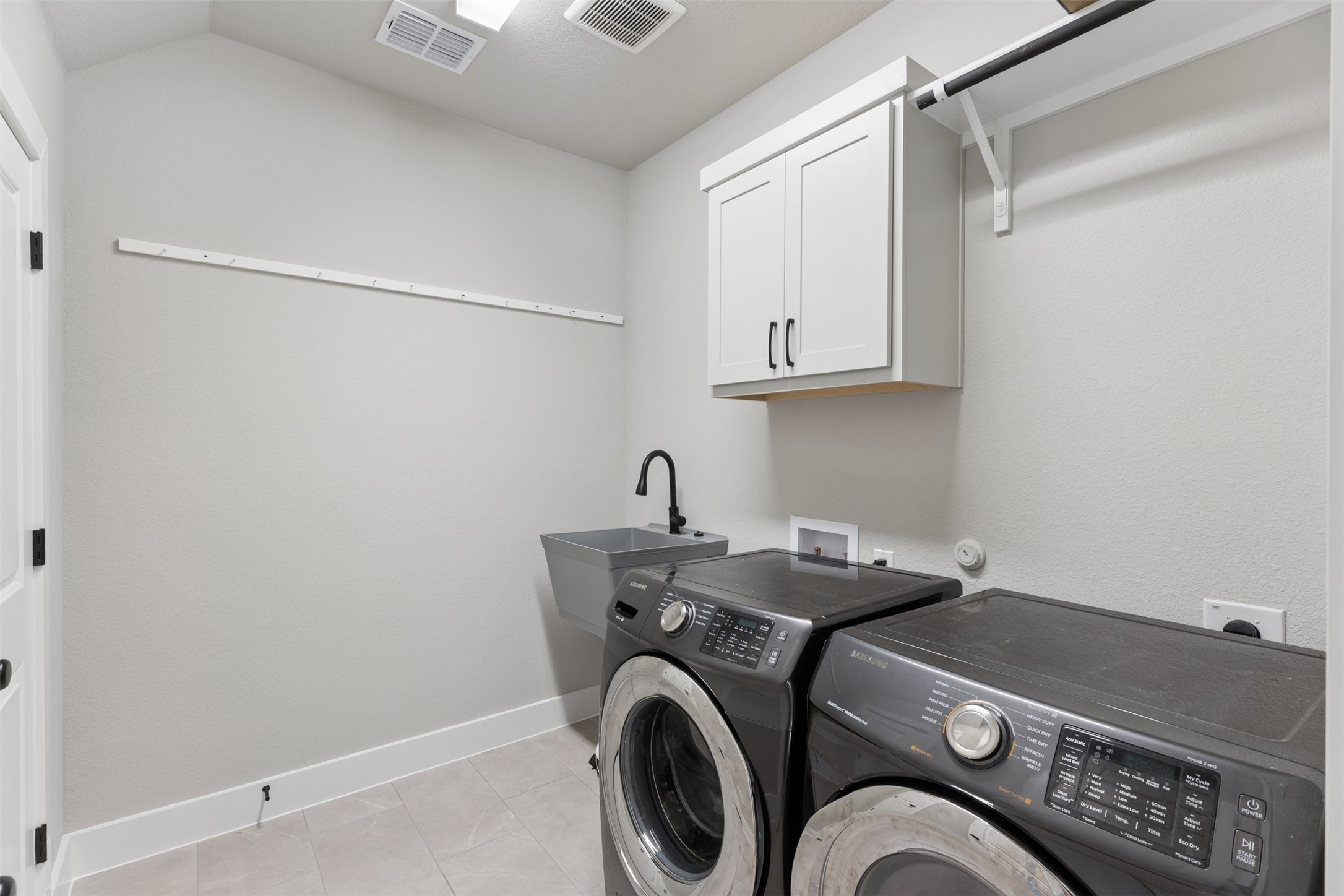 1508 Cardinal Lane Round Rock, TX 78681 - Photo 33 of 35 Laundry room with cabinet space and independent washer and dryer