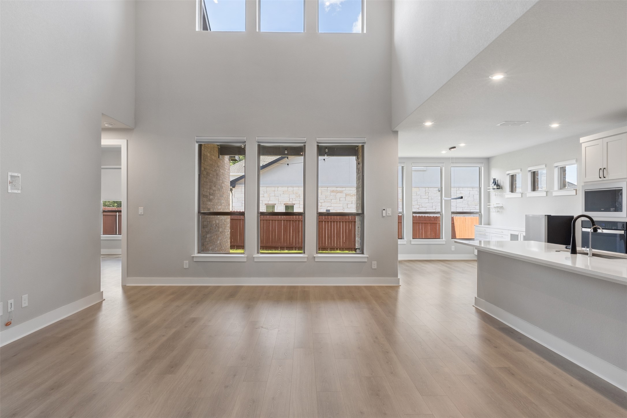 1508 Cardinal Lane Round Rock, TX 78681 - Photo 10 of 35 Unfurnished living room with light wood-style floors and a high ceiling