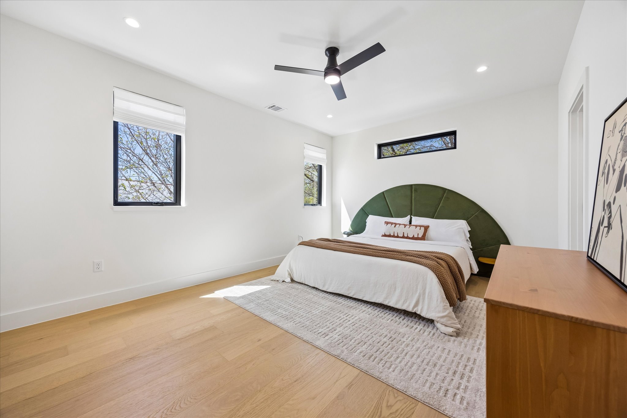 4416 South 1st Street, Unit 2 Austin, TX 78745 - Photo 16 of 33 a bedroom with a bed and a ceiling fan