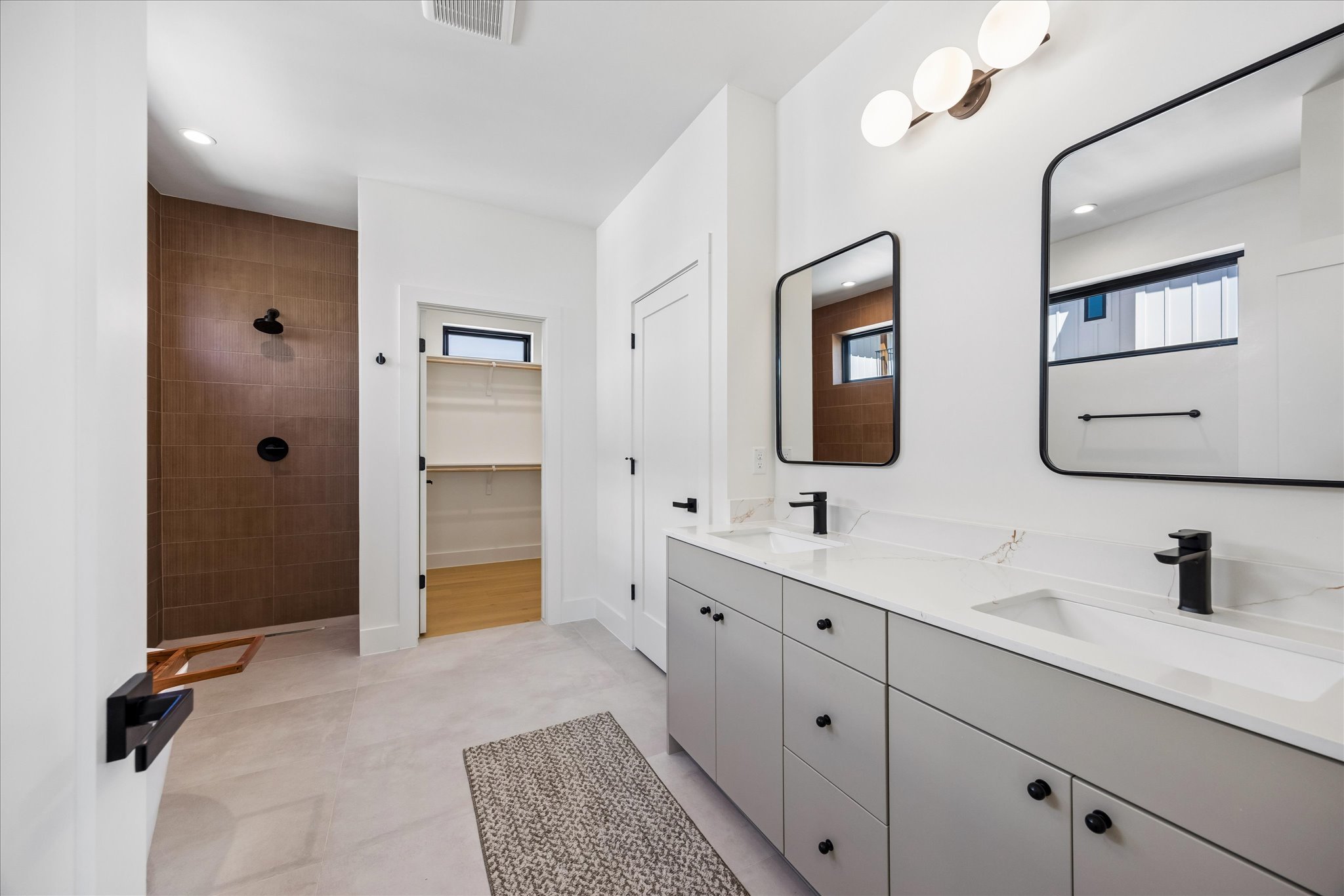 4416 South 1st Street, Unit 2 Austin, TX 78745 - Photo 17 of 33 a bathroom with a double vanity sink and mirror