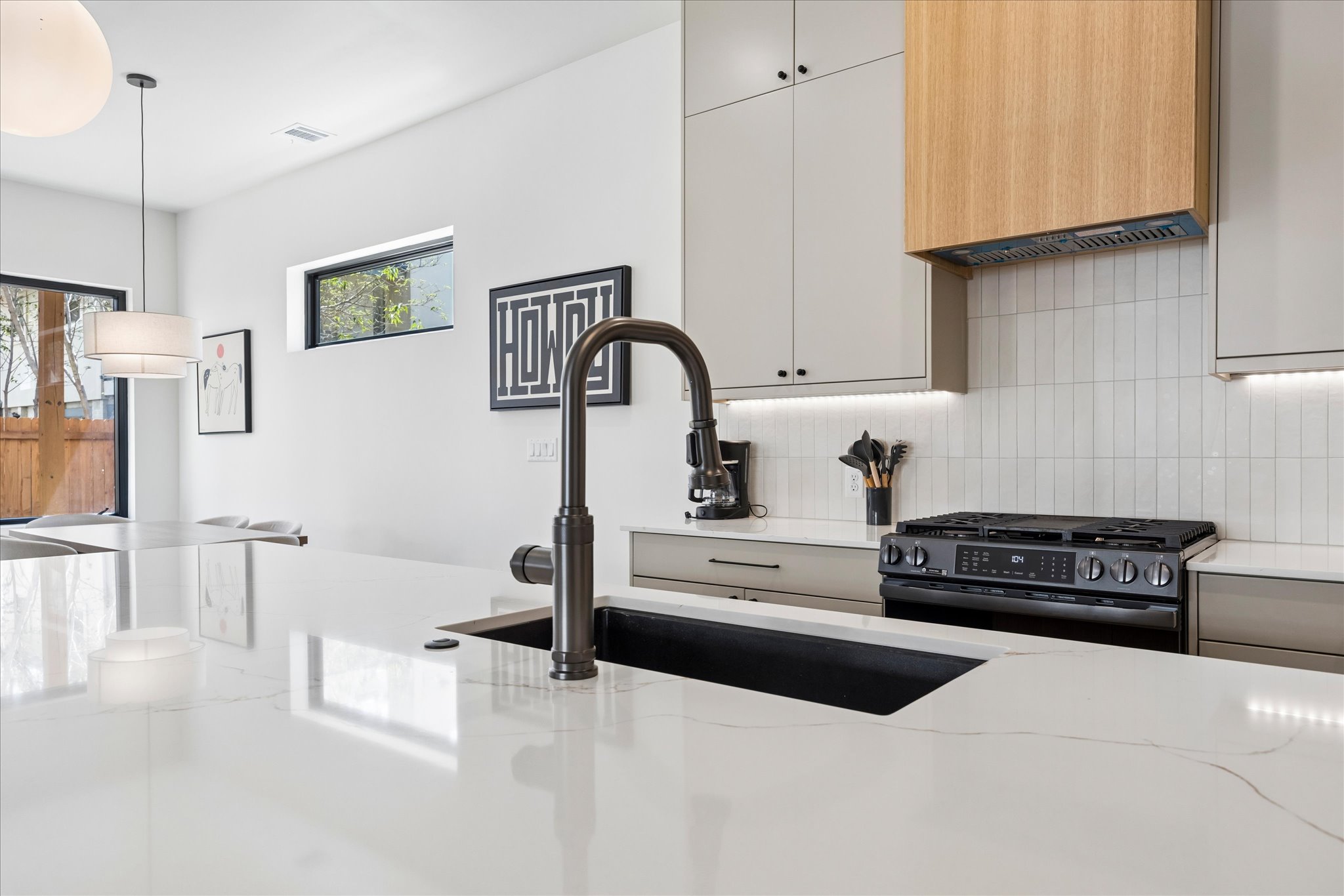 4416 South 1st Street, Unit 2 Austin, TX 78745 - Photo 6 of 33 a kitchen with stainless steel appliances granite countertop a stove and a refrigerator
