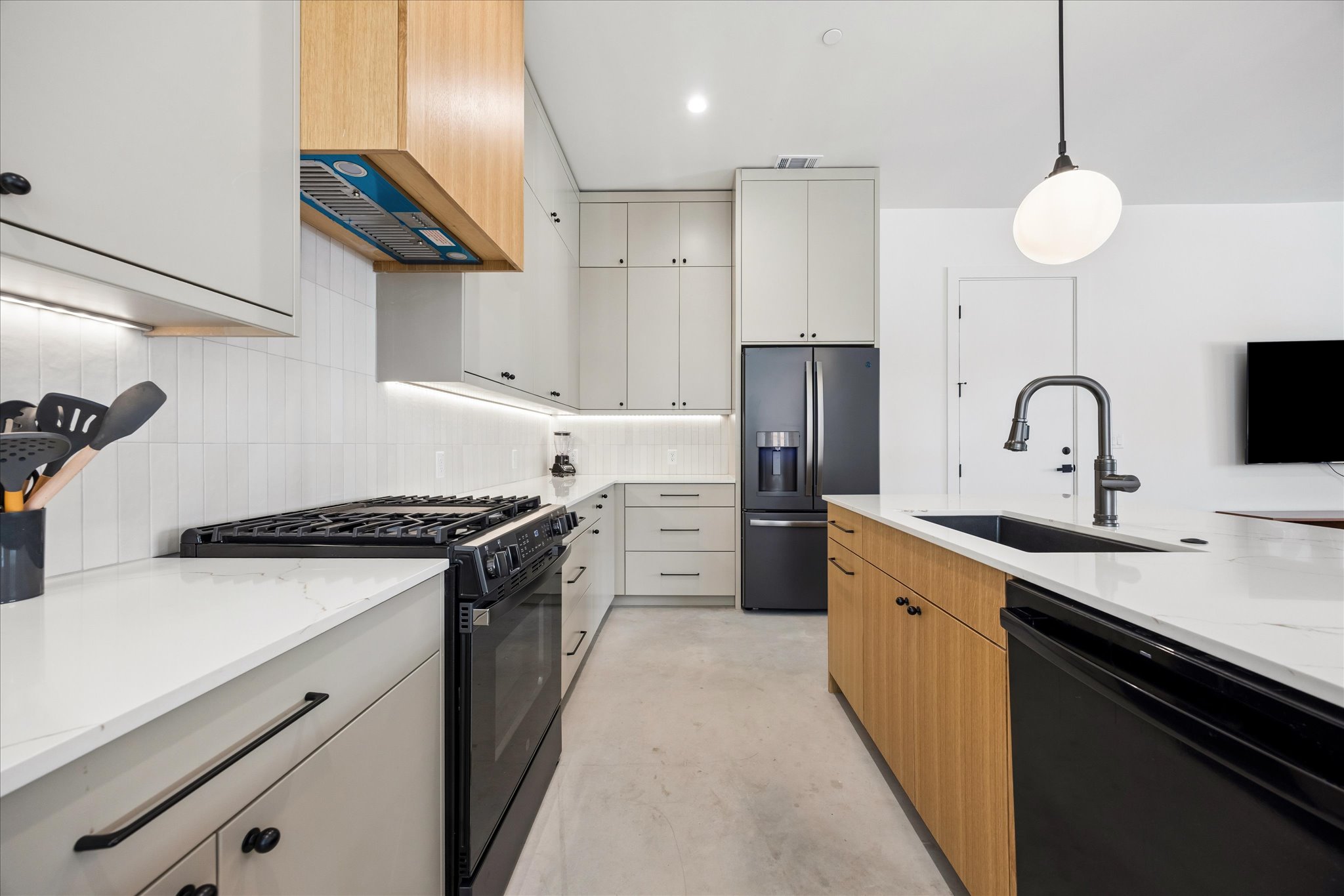 4416 South 1st Street, Unit 2 Austin, TX 78745 - Photo 7 of 33 a kitchen with stainless steel appliances granite countertop a sink a stove and a refrigerator