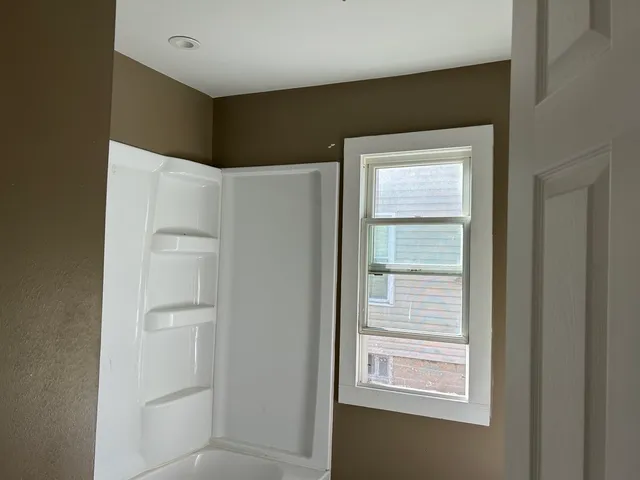 a view of an empty room with a window