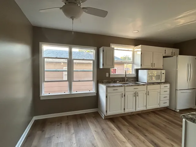 a kitchen with refrigerator and window