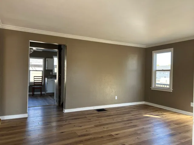 wooden floor in an empty room with a window