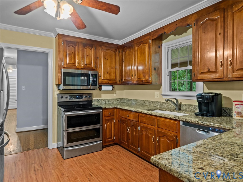 3420 State Rte 656 Powhatan, VA 23139 - Photo 11 of 37 a kitchen with stainless steel appliances granite countertop wooden cabinets a stove top oven a sink and dishwasher