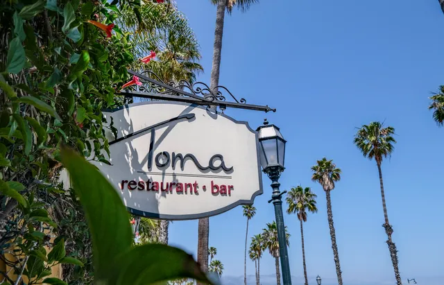 a view of sign board with a small yard