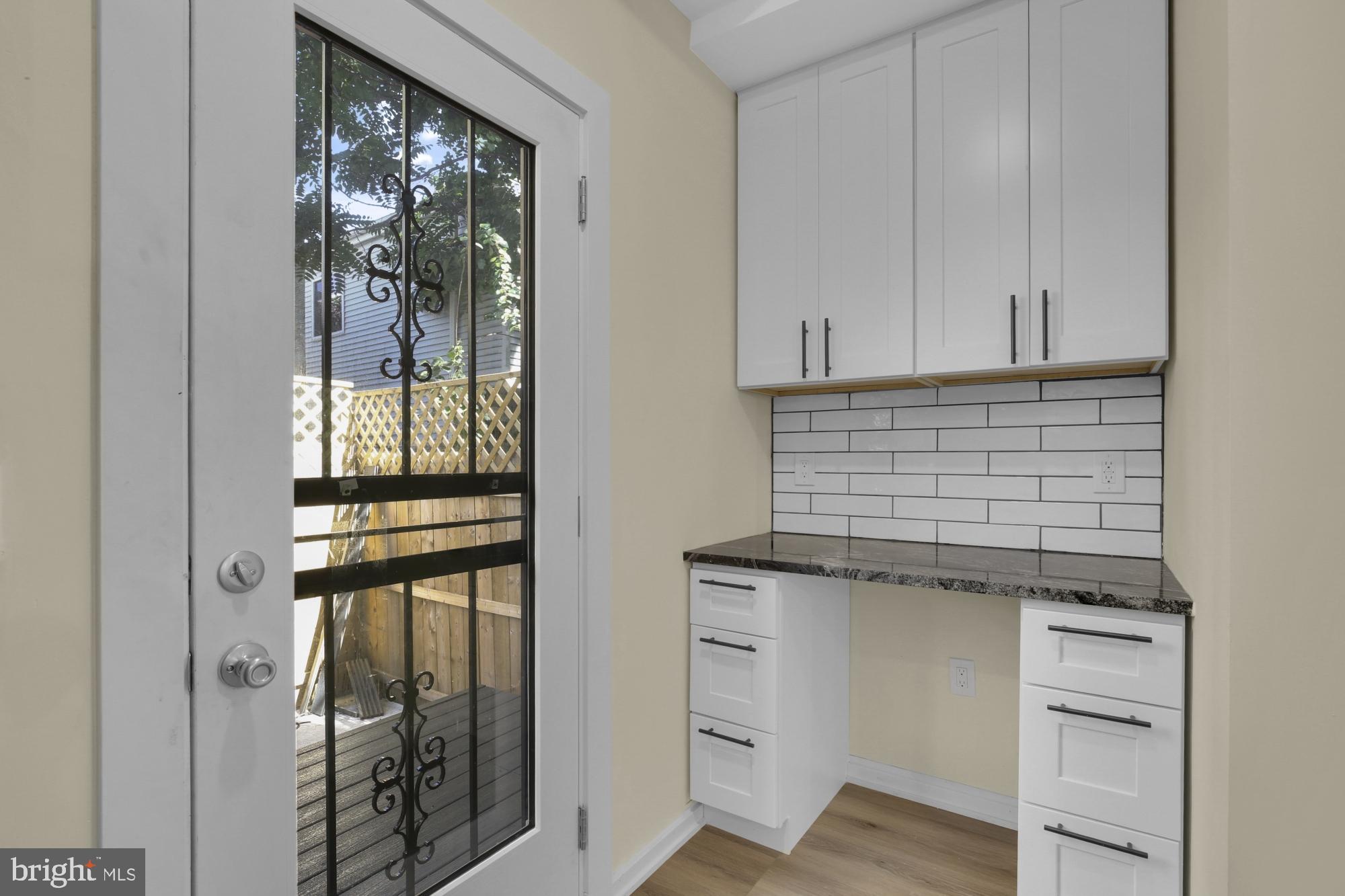 2670 Braddock Street Philadelphia, PA 19125 - Photo 11 of 47 a kitchen with white cabinets and a sink