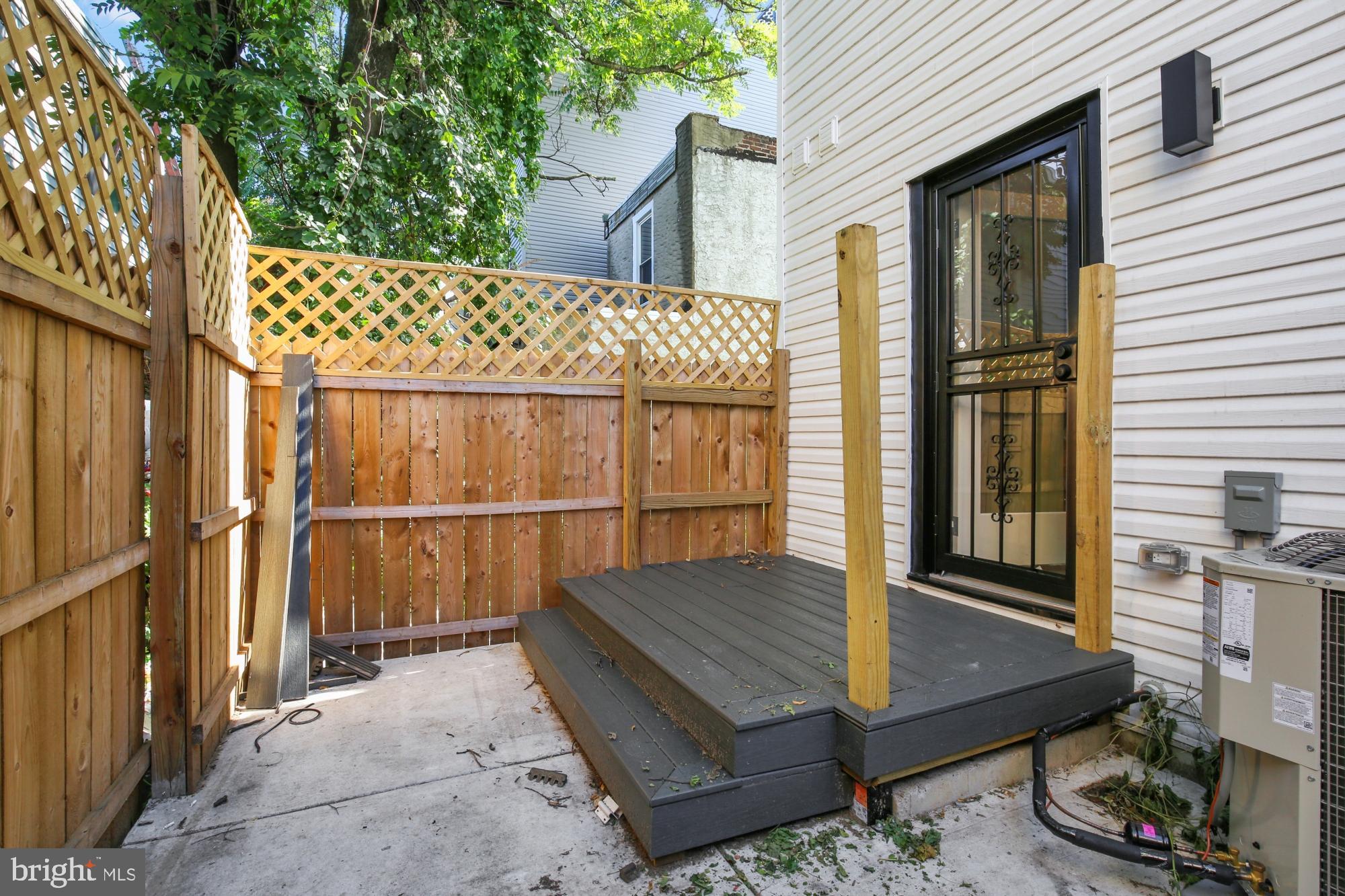 2670 Braddock Street Philadelphia, PA 19125 - Photo 12 of 47 a view of backyard with barbeque oven and wooden fence