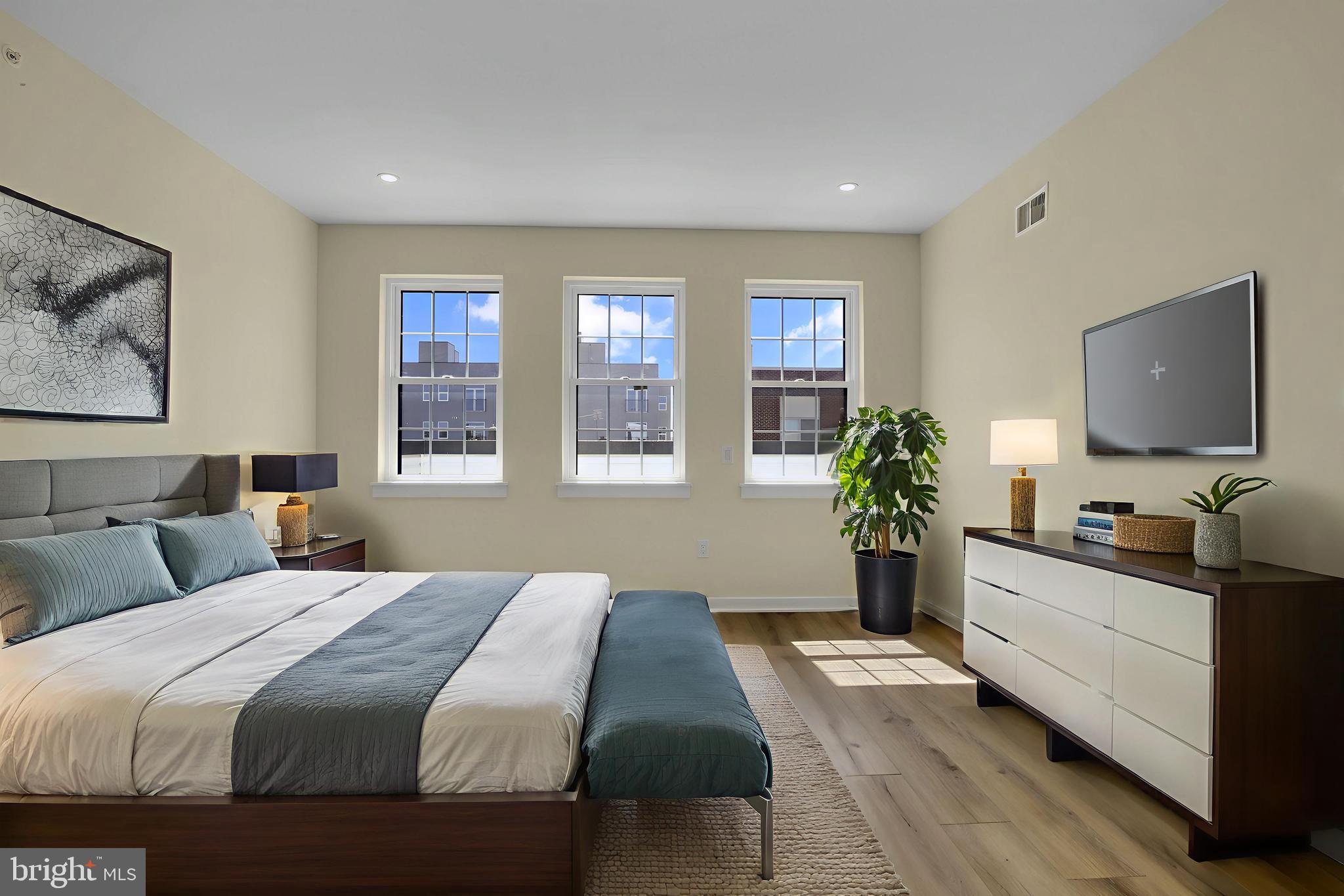 2670 Braddock Street Philadelphia, PA 19125 - Photo 2 of 47 a bedroom with a large bed and a flat screen tv