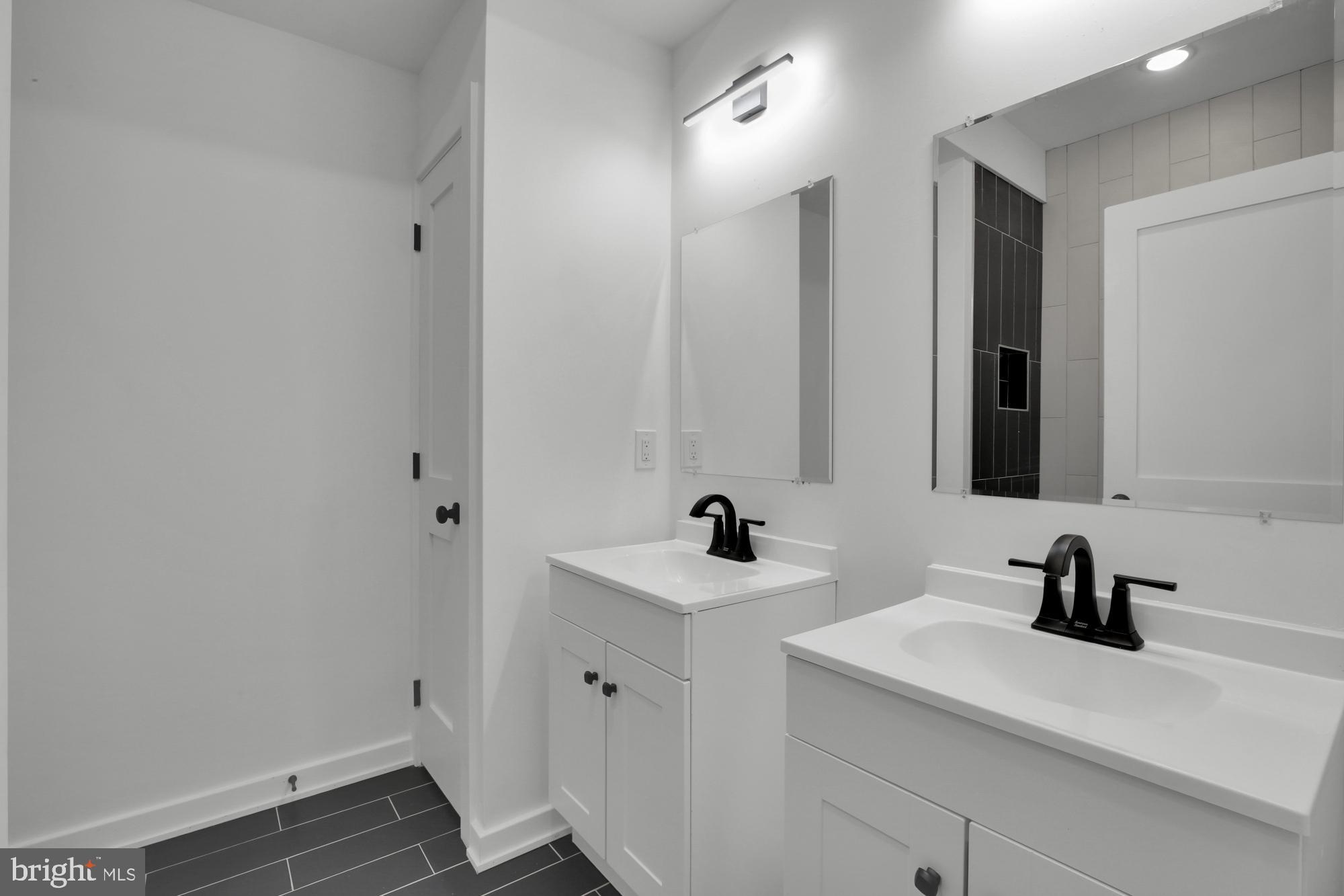 2670 Braddock Street Philadelphia, PA 19125 - Photo 23 of 47 a bathroom with a sink and a mirror