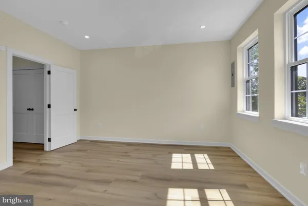 a view of a hallway with stairs and wooden floor