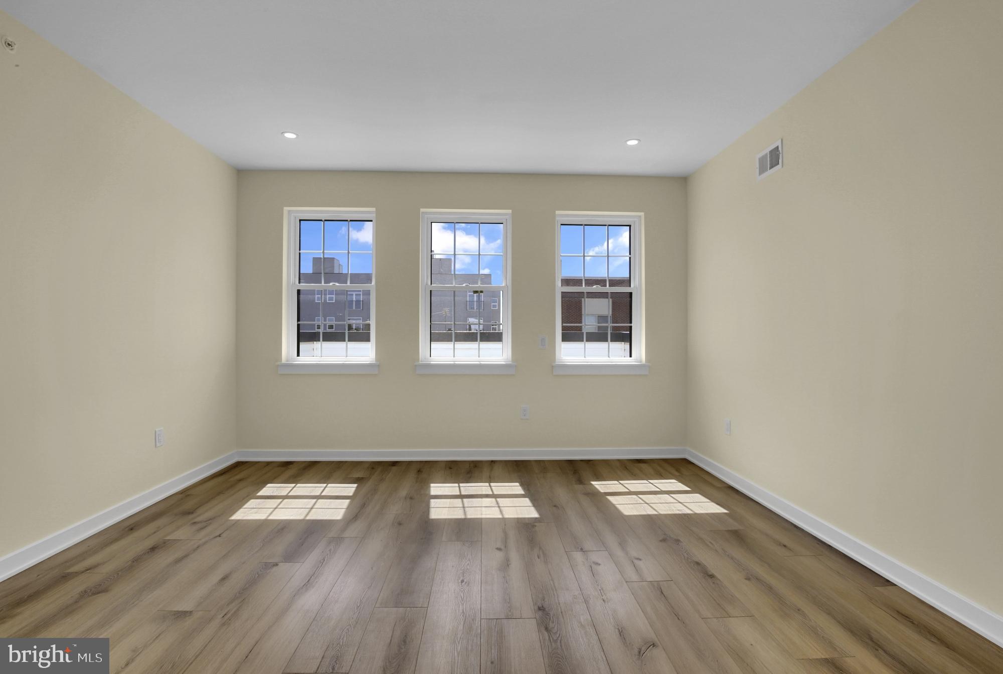 2670 Braddock Street Philadelphia, PA 19125 - Photo 32 of 47 an empty room with wooden floor and windows