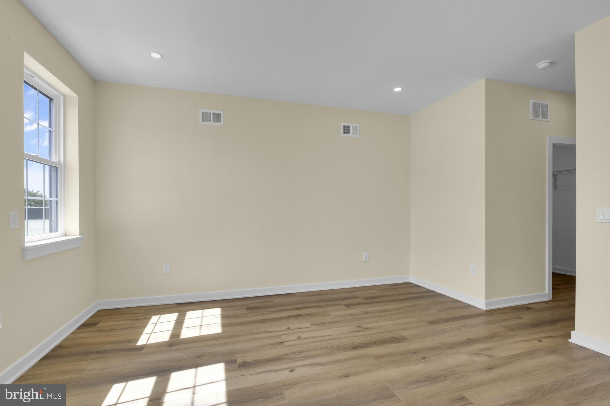 2670 Braddock Street Philadelphia, PA 19125 - Photo 35 of 47 a view of an empty room with wooden floor and a window