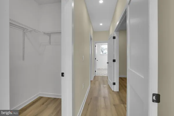 a view of a hallway with wooden floor