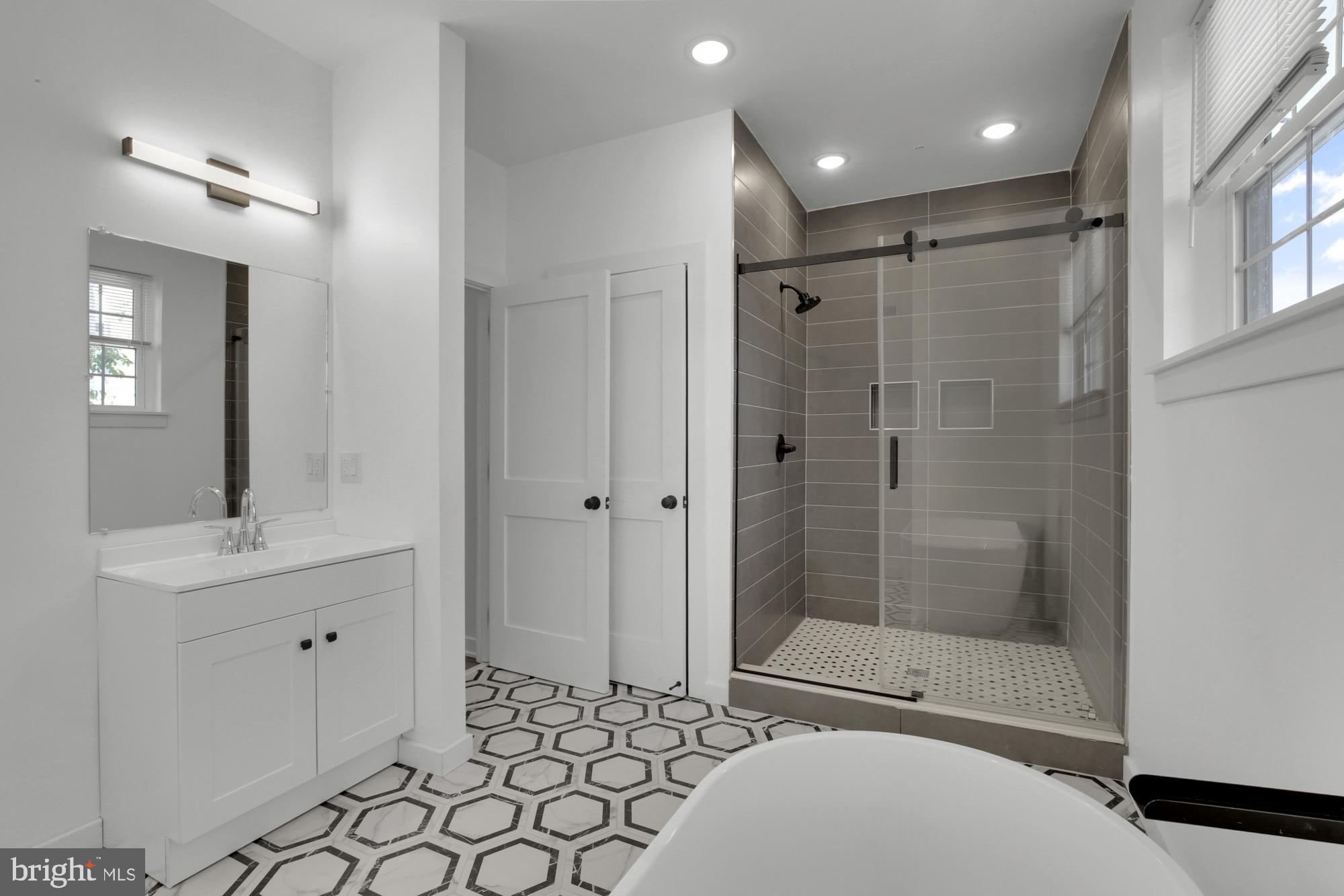 2670 Braddock Street Philadelphia, PA 19125 - Photo 40 of 47 a bathroom with a shower a sink and mirror