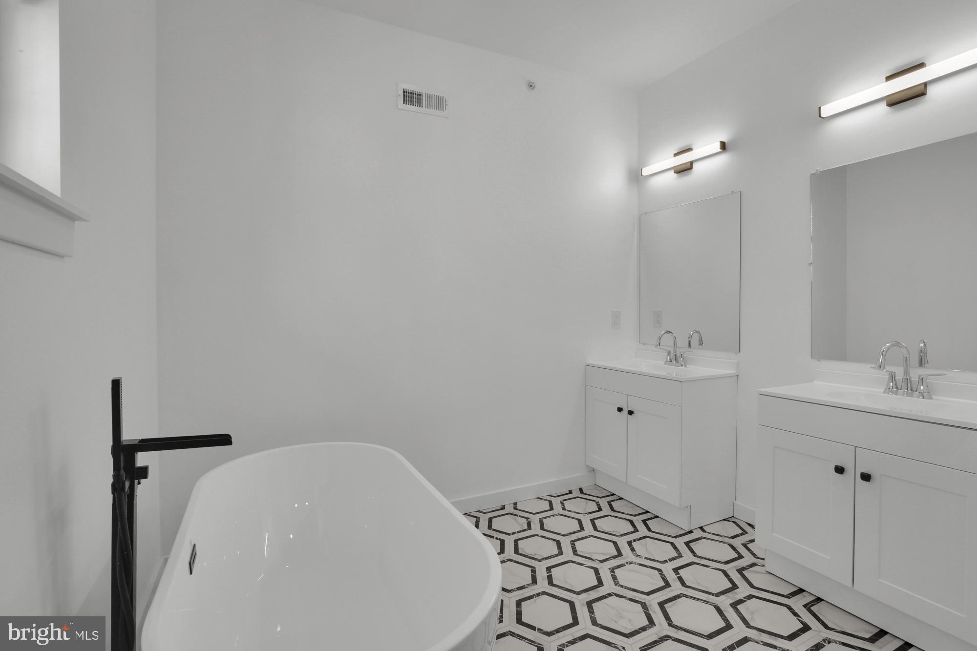 2670 Braddock Street Philadelphia, PA 19125 - Photo 42 of 47 a bathroom with a sink and a mirror